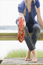 Portrait of woman holding lobster on deck. Date: 2008
