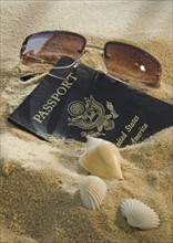 United States passport, sunglasses, and seashells.