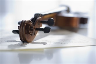Violin laying on sheet music.