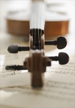 Close up of violin bow on sheet music.