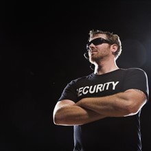 Security guard standing with arms crossed. Date : 2008