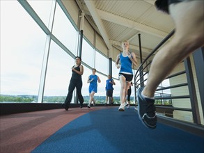 Runners on indoor track. Date: 2008