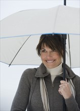 Woman with umbrella smiling.