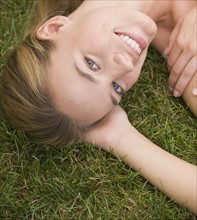 Close up of woman laying in grass.