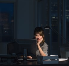 Businesswoman working late in office.