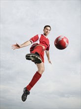 Soccer player kicking soccer ball in mid-air. Date: 2008