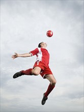 Soccer player and soccer ball in mid-air. Date : 2008