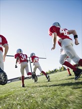 Football players running on field. Date : 2008