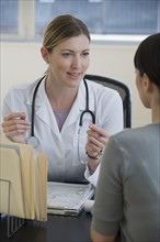 Female doctor consulting female patient.