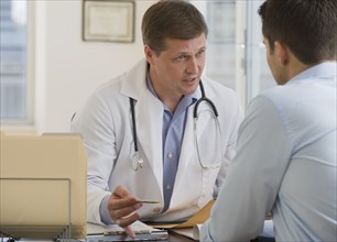 Male doctor consulting female patient.