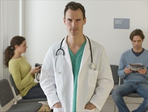 Male doctor posing in waiting room.