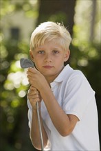 Portrait of boy with golf club. Date : 2008