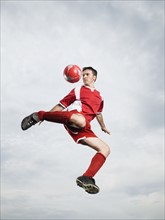 Soccer player kicking soccer ball in mid-air. Date : 2008