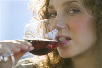 Close up portrait of woman drinking red wine.