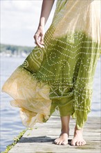 Wind blowing dress of woman standing on dock. Date : 2008