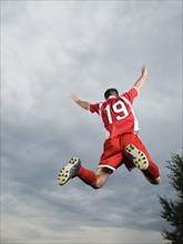 Soccer player jumping in mid-air with arms raised. Date : 2008