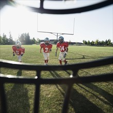 View of football players and field from inside helmet. Date: 2008