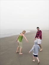 Parents and son on beach. Date: 2008