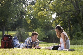 College students studying in grass. Date : 2008