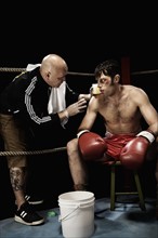 Coach talking to boxer in corner of boxing ring. Date: 2008