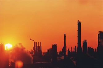 Sun setting on oil refinery in Baytown, Texas. Date : 2008