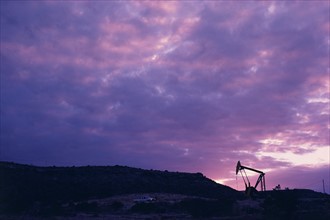 Oil rig in distance under sunset sky. Date: 2008