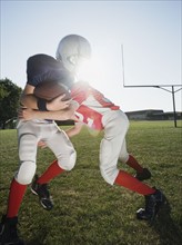Football player tackling opponent. Date: 2008