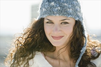 Portrait of smiling woman in stocking cap.