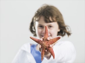Portrait of girl holding starfish. Date: 2008