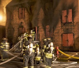 Firefighters at burning building. Date: 2008