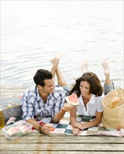 Couple picnicking on dock. Date : 2008