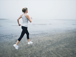 Woman jogging on beach. Date : 2008