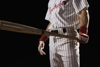 Baseball player holding bat. Date : 2008