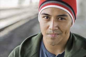 Portrait of young man with stocking cap smiling. Date: 2008