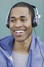 Close up of young man listening to headphones. Date : 2008