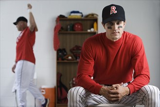 Baseball player looking pensive in locker room. Date : 2008