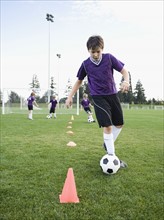 Boy practicing soccer drills. Date : 2008