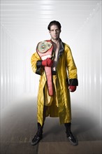 Boxer in robe posing with championship belt. Date : 2008