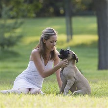 Woman petting dog in park. Date: 2008