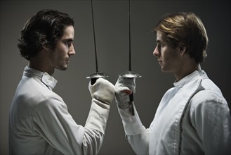 Fencers facing off with fencing foils. Date: 2008