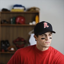 Baseball player looking pensive in locker room. Date: 2008