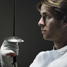 Close up of man holding fencing foil. Date: 2008