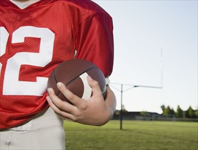 Close up of football player holding football on field. Date: 2008