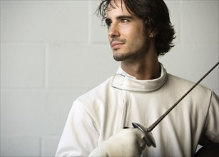 Portrait of fencer holding fencing foil. Date: 2008