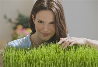 Portrait of woman touching grass.