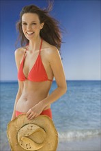 Portrait of woman in bikini on beach.