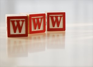 Alphabet blocks forming ”WWW”.