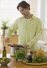 Man preparing meal in kitchen.