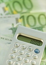 Calculator and 100 euro notes.