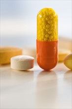 Close up of medicine capsule and pills.